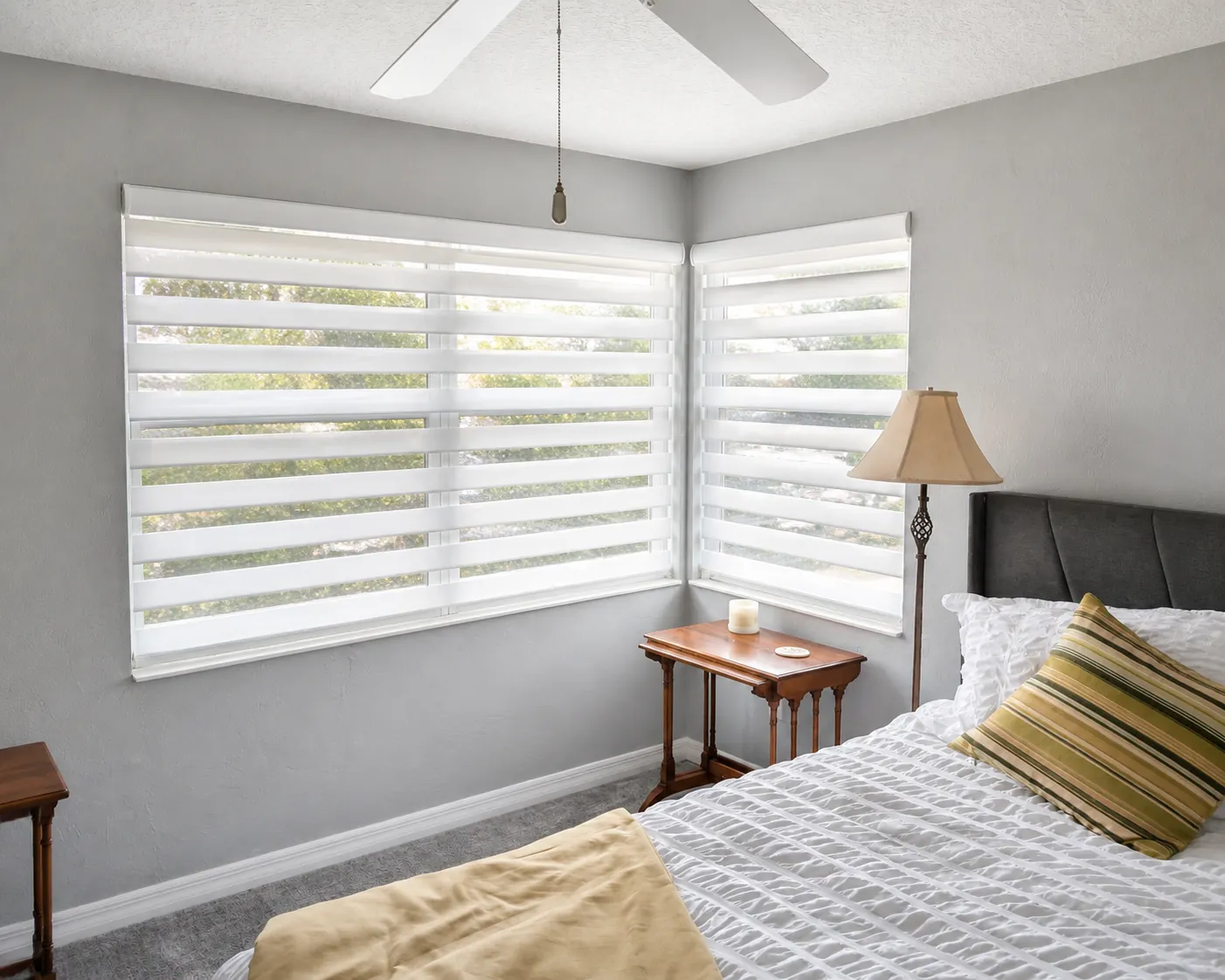 Custom white zebra shades providing filtered light and privacy in a Nocatee bedroom