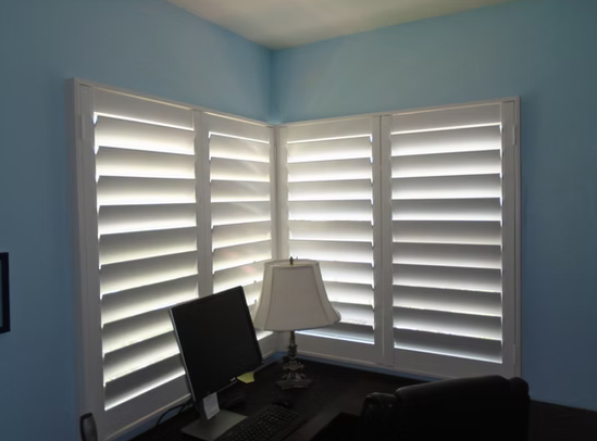 Corner window plantation shutters in a Nocatee home office