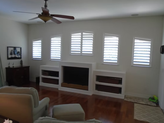 Five custom plantation shutters surrounding a fireplace in a Nocatee home