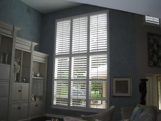 Two-story plantation shutter installation in a Nocatee living room