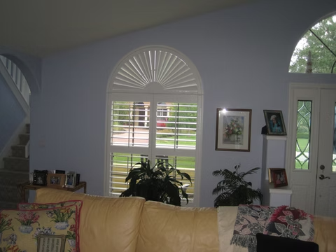 Sunburst and rectangular plantation shutters in a Nocatee living room